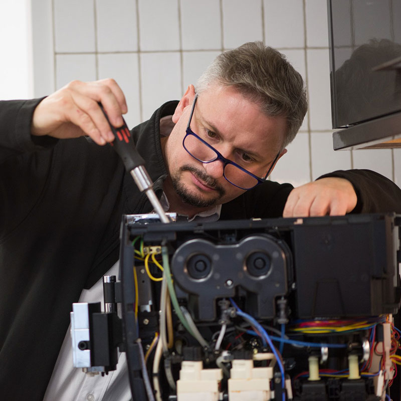 Technician working on coffee machine