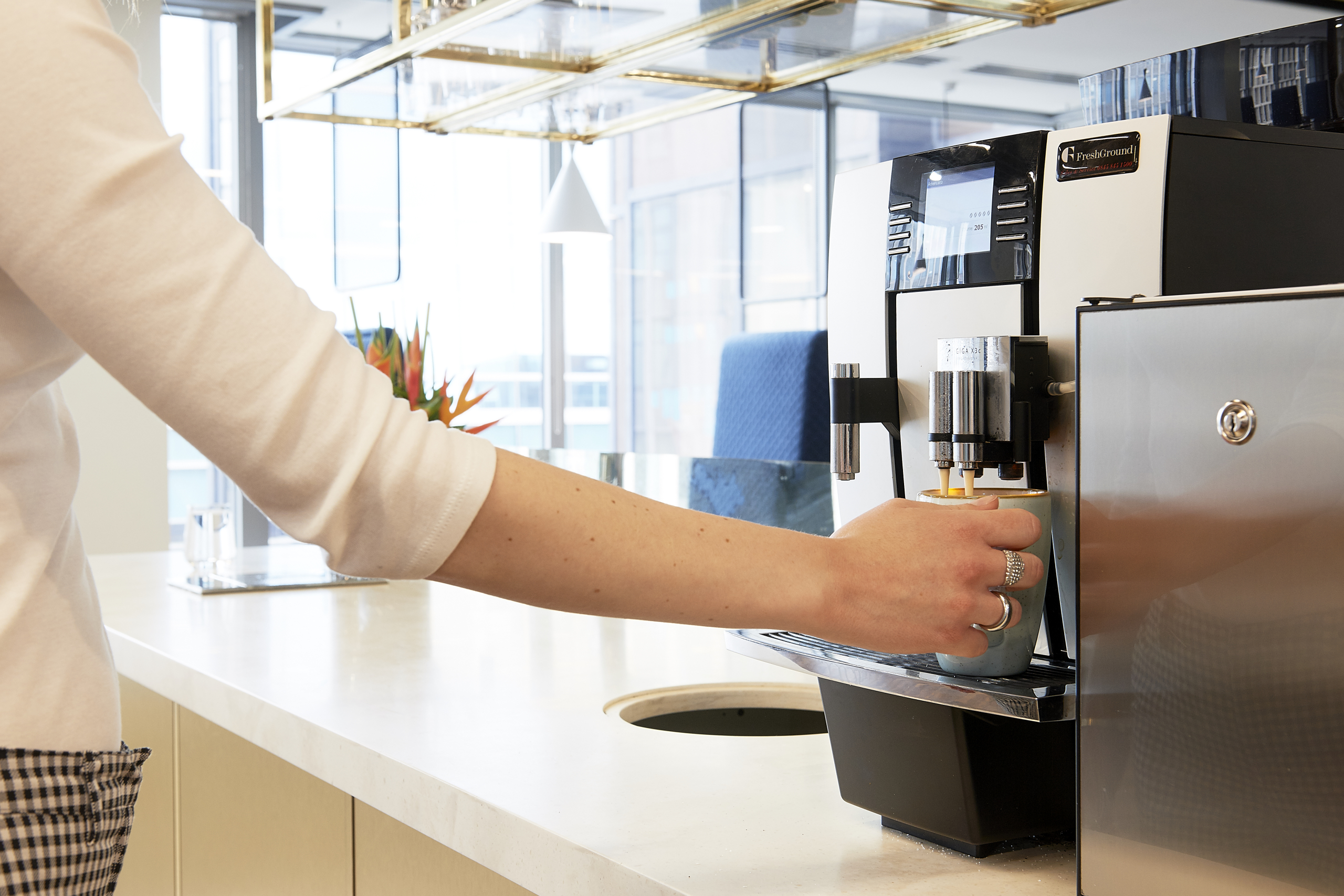 woman using coffee machine