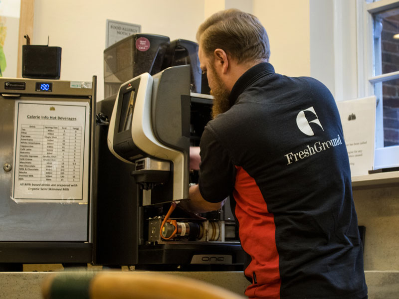 man fixing coffee machine