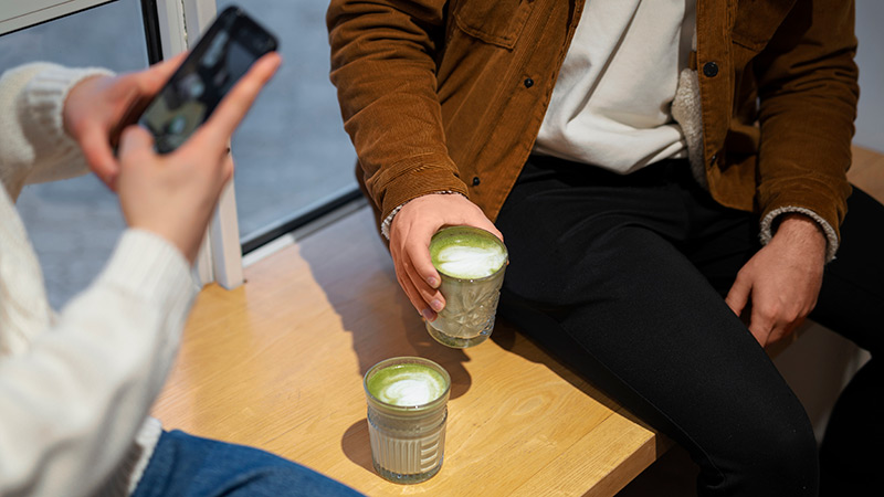 Two people enjoying matcha lattes