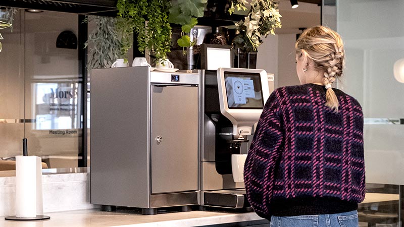 Person using a coffee machine