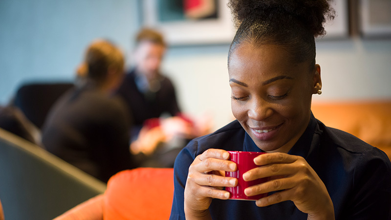 Woman enjoying FreshGround coffee