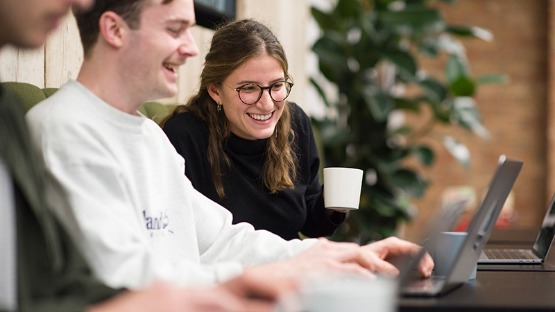 Colleagues drinking coffee whilst working